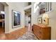 Inviting foyer with hardwood floors, elegant décor, and an open staircase at 9351 Viaggio Way, Highlands Ranch, CO 80126