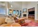 Bright living room with fireplace, plantation shutters and comfortable seating arrangement at 9351 Viaggio Way, Highlands Ranch, CO 80126