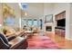 Spacious living room features a fireplace, large windows, and hardwood floors at 9351 Viaggio Way, Highlands Ranch, CO 80126