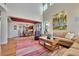 Bright living room featuring high ceilings, fireplace, and view into dining area at 9351 Viaggio Way, Highlands Ranch, CO 80126