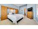 Comfortable main bedroom with built-in shelving and adjacent bath at 9351 Viaggio Way, Highlands Ranch, CO 80126