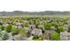 Overhead shot of a community featuring tree-lined streets, well-kept lawns, and diverse housing styles with mountain backdrop at 9631 S Dover Way, Littleton, CO 80127