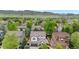 Aerial view of a neighborhood showcasing well-maintained homes, mature trees, and picturesque mountain views in the background at 9631 S Dover Way, Littleton, CO 80127