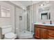 Modern bathroom with a glass-enclosed shower, updated fixtures, and a vanity with storage at 9631 S Dover Way, Littleton, CO 80127