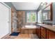 Luxurious bathroom featuring a glass enclosed shower, soaking tub, and custom cabinets with granite countertop at 9631 S Dover Way, Littleton, CO 80127