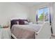 Bright bedroom offers a cozy ambiance with a comfortable bed and soft lighting at 9631 S Dover Way, Littleton, CO 80127