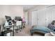 Cozy bedroom featuring a work space, closet space, and a comfortable chaise lounge for relaxation at 9631 S Dover Way, Littleton, CO 80127