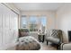 Bright bedroom with large windows, a comfortable chaise lounge, and ample closet space create a relaxing retreat at 9631 S Dover Way, Littleton, CO 80127