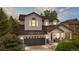 Charming two-story home featuring a well-manicured lawn, inviting porch and attached two car garage at 9631 S Dover Way, Littleton, CO 80127