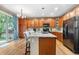 Spacious kitchen with large island, granite countertops, wood cabinets, and modern appliances at 9631 S Dover Way, Littleton, CO 80127