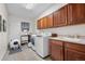 Functional laundry room featuring modern appliances, ample cabinet space, and easy access door at 9631 S Dover Way, Littleton, CO 80127