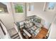 Spacious living room with large windows, hardwood floors, dining table, and tasteful decor at 9631 S Dover Way, Littleton, CO 80127
