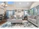 Elegant living room featuring high ceilings, ample natural light, and stylish furnishings at 9631 S Dover Way, Littleton, CO 80127