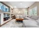 Inviting living room with built-in shelving, large windows, and comfortable seating at 9631 S Dover Way, Littleton, CO 80127