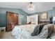 Beautiful bedroom with vaulted ceiling, a large armoire, and neutral-toned decor create a serene atmosphere at 9631 S Dover Way, Littleton, CO 80127