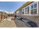 Landscaped backyard featuring a fire pit, gravel beds, and outdoor seating at 14969 Elsinore Ave, Parker, CO 80134
