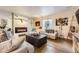 Cozy basement with a brick fireplace, comfortable seating, and unique decor at 14969 Elsinore Ave, Parker, CO 80134
