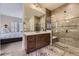 Modern bathroom featuring a glass-enclosed shower, dual vanity, and tile flooring at 14969 Elsinore Ave, Parker, CO 80134