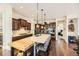 Modern kitchen with a large island, stainless steel appliances, and dark wood cabinets at 14969 Elsinore Ave, Parker, CO 80134