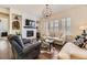 Comfortable living room with a stone fireplace, large windows, and a cozy seating area at 14969 Elsinore Ave, Parker, CO 80134