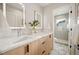 Modern bathroom with double vanity, marble countertop, and glass-enclosed shower at 2330 Eliot St # 2, Denver, CO 80211