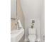 Modern powder room features a wall-mounted sink, updated fixtures, and decorative tile wall at 2330 Eliot St # 2, Denver, CO 80211