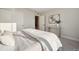 Bright bedroom with a comfortable bed, neutral decor, and a decorative wall art at 2330 Eliot St # 2, Denver, CO 80211
