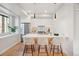 Bright kitchen with stainless steel appliances, pendant lighting, island, and modern white cabinetry at 2330 Eliot St # 2, Denver, CO 80211