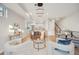 Open-concept living area with modern furnishings, leading to a well-equipped kitchen and staircase at 2330 Eliot St # 2, Denver, CO 80211