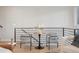 Cozy sitting area with two armchairs, round table, black railings, and hardwood flooring at 2330 Eliot St # 2, Denver, CO 80211