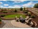 Relaxing backyard seating area with a fire pit, surrounded by beautiful landscaping and a multi-tiered retaining wall at 3325 Umber Cir, Castle Rock, CO 80109
