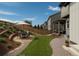 Landscaped backyard featuring a stone patio with seating, lush lawn, and manicured garden beds for outdoor enjoyment at 3325 Umber Cir, Castle Rock, CO 80109
