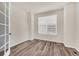 Neutral room featuring modern wood flooring, a window, and a bright and airy atmosphere at 3325 Umber Cir, Castle Rock, CO 80109