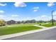Scenic neighborhood park with a lush lawn, walking paths, and picturesque residential surroundings at 3325 Umber Cir, Castle Rock, CO 80109