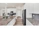 Well-equipped kitchen with sleek stainless steel appliances and gray subway tile backsplash at 3325 Umber Cir, Castle Rock, CO 80109