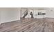 Spacious living area showcasing modern wood flooring, an open layout to the kitchen and a staircase at 3325 Umber Cir, Castle Rock, CO 80109