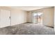 Spacious bedroom with plush carpet and sliding glass door to private balcony at 10211 Ura Ln # 304, Thornton, CO 80260