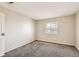 Bright bedroom featuring plush carpet, a window with blinds, and neutral walls at 10211 Ura Ln # 304, Thornton, CO 80260