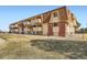 Apartment building with unique exterior design, private balconies, and well-maintained landscaping at 10211 Ura Ln # 304, Thornton, CO 80260
