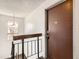 Hallway view featuring a stairwell, hanging lamp, and the front door to an apartment numbered 304 at 10211 Ura Ln # 304, Thornton, CO 80260