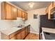 Functional kitchen features wooden cabinets, laminate countertops, and essential appliances at 10211 Ura Ln # 304, Thornton, CO 80260