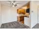 Cozy living space featuring neutral paint, a ceiling fan, and convenient kitchen access at 10211 Ura Ln # 304, Thornton, CO 80260