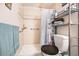 Clean bathroom featuring a walk-in shower with tile surround and metal shelving unit at 650 S Clinton St # 11B, Denver, CO 80247