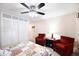 Bedroom with closet, ceiling fan, and a comfortable seating area at 650 S Clinton St # 11B, Denver, CO 80247