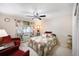 Bright bedroom with ceiling fan, cozy seating area, and colorful quilt bedding at 650 S Clinton St # 11B, Denver, CO 80247