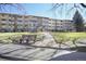 Apartment building with a well-maintained lawn and mature trees at 650 S Clinton St # 11B, Denver, CO 80247
