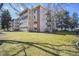 Exterior image of condo building with manicured green lawn at 650 S Clinton St # 11B, Denver, CO 80247