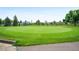 Expansive golf green with mature trees and a wooden fence surround at 650 S Clinton St # 11B, Denver, CO 80247