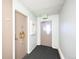 Hallway with apartment doors, carpet, and an exit sign at 650 S Clinton St # 11B, Denver, CO 80247