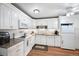 Bright kitchen featuring white cabinets, stainless steel appliances, and granite countertops at 650 S Clinton St # 11B, Denver, CO 80247